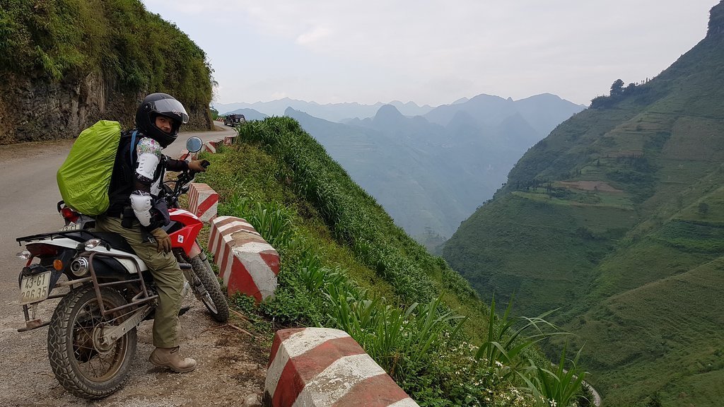 stopping on a Honda XR150 to admire the mountainous view