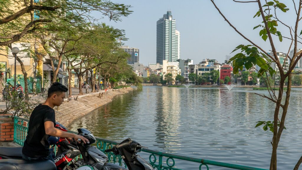 a local man parking his bike by Truc Bach Lake