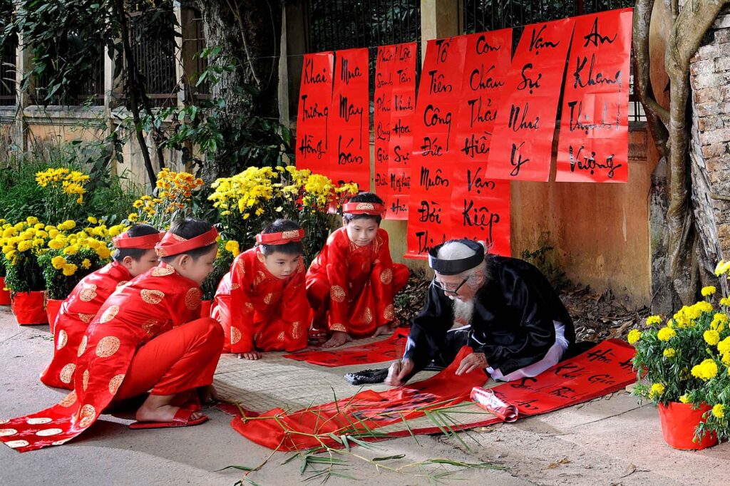 writing good wishes on scrolls for tet gifts