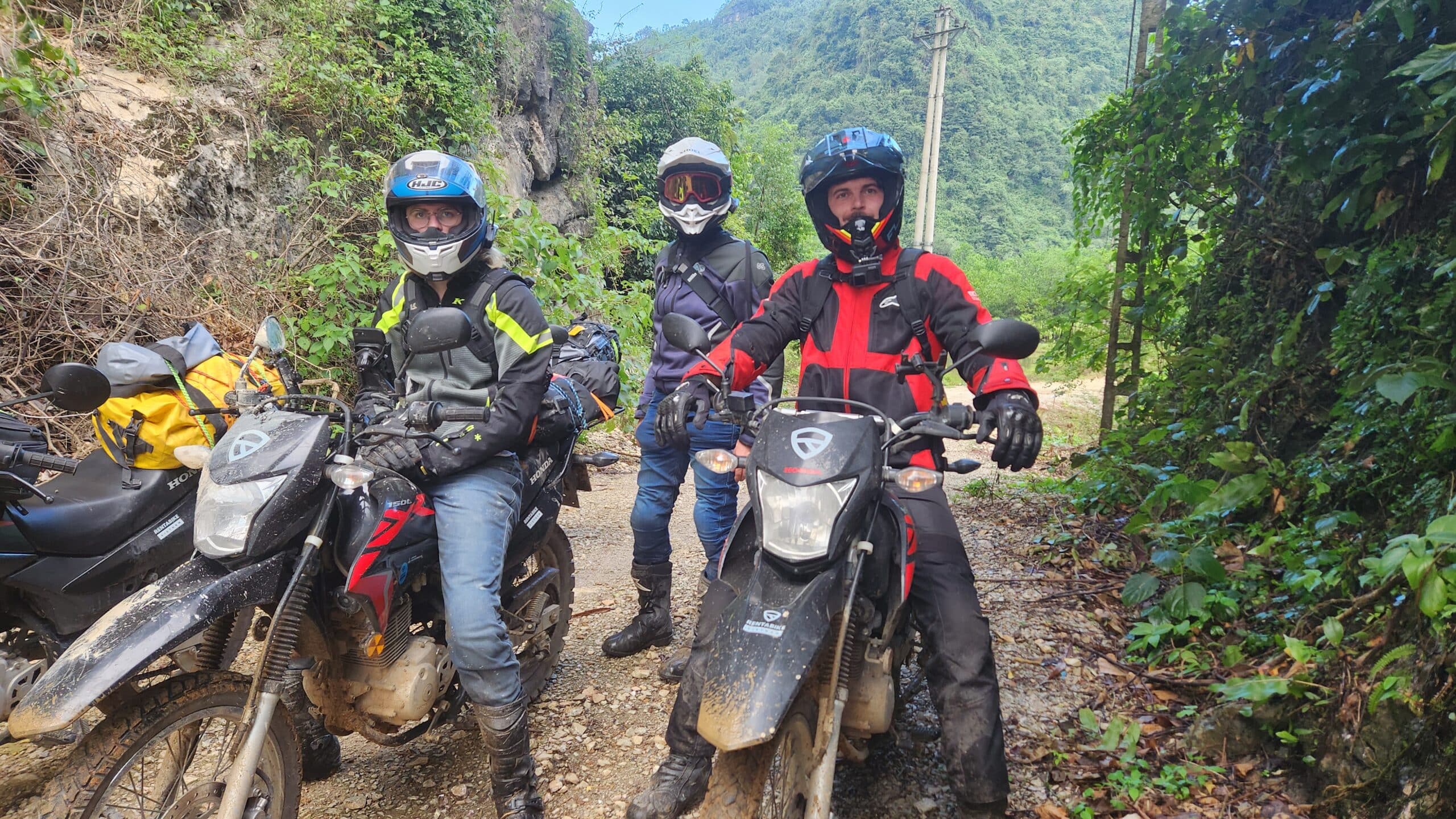 Rentabike Vietnam motorcycle tour members parked up on a Ha Giang country road