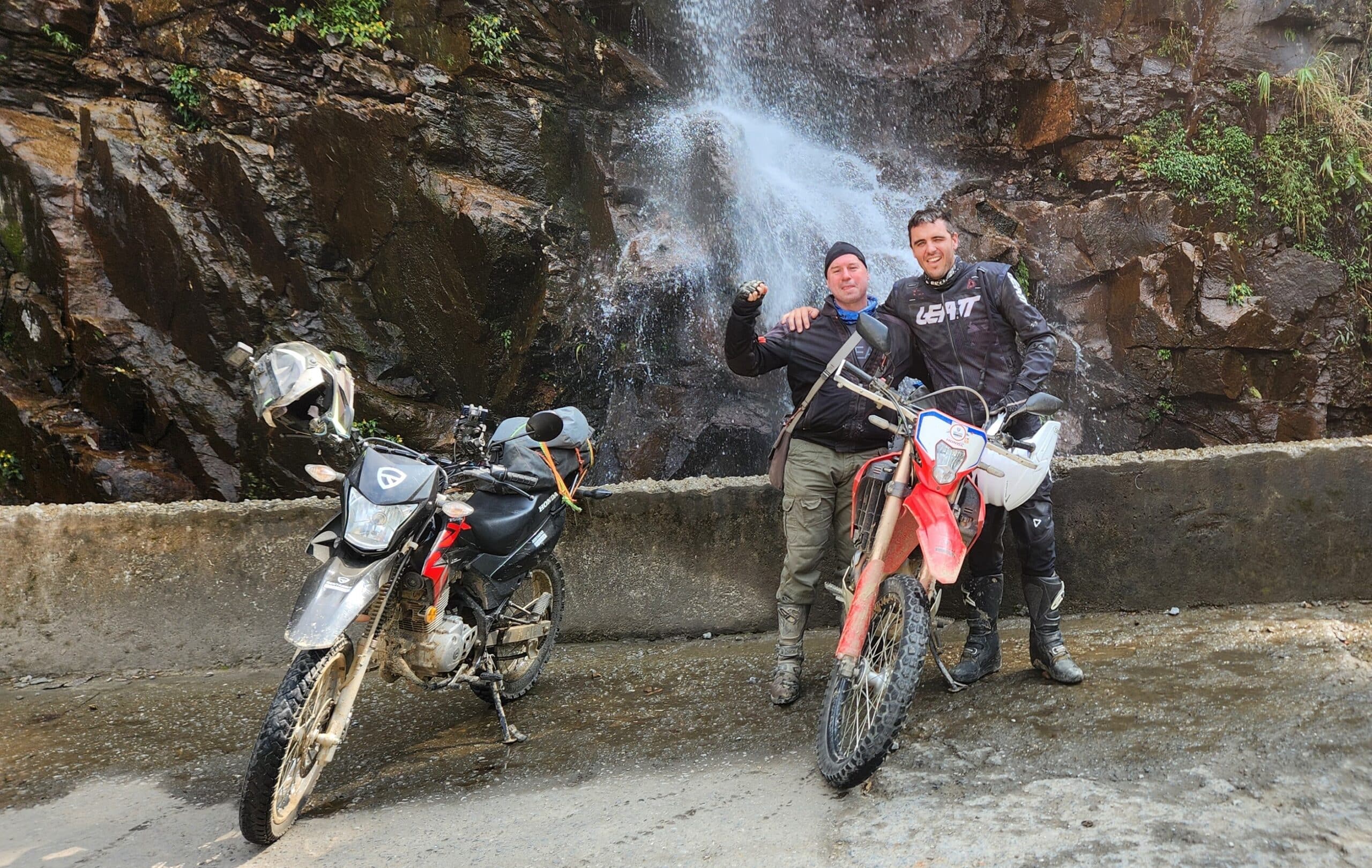 Tom and Danny on the Honda XR150 and the Honda CRF300 at a waterfall in Ha Giang
