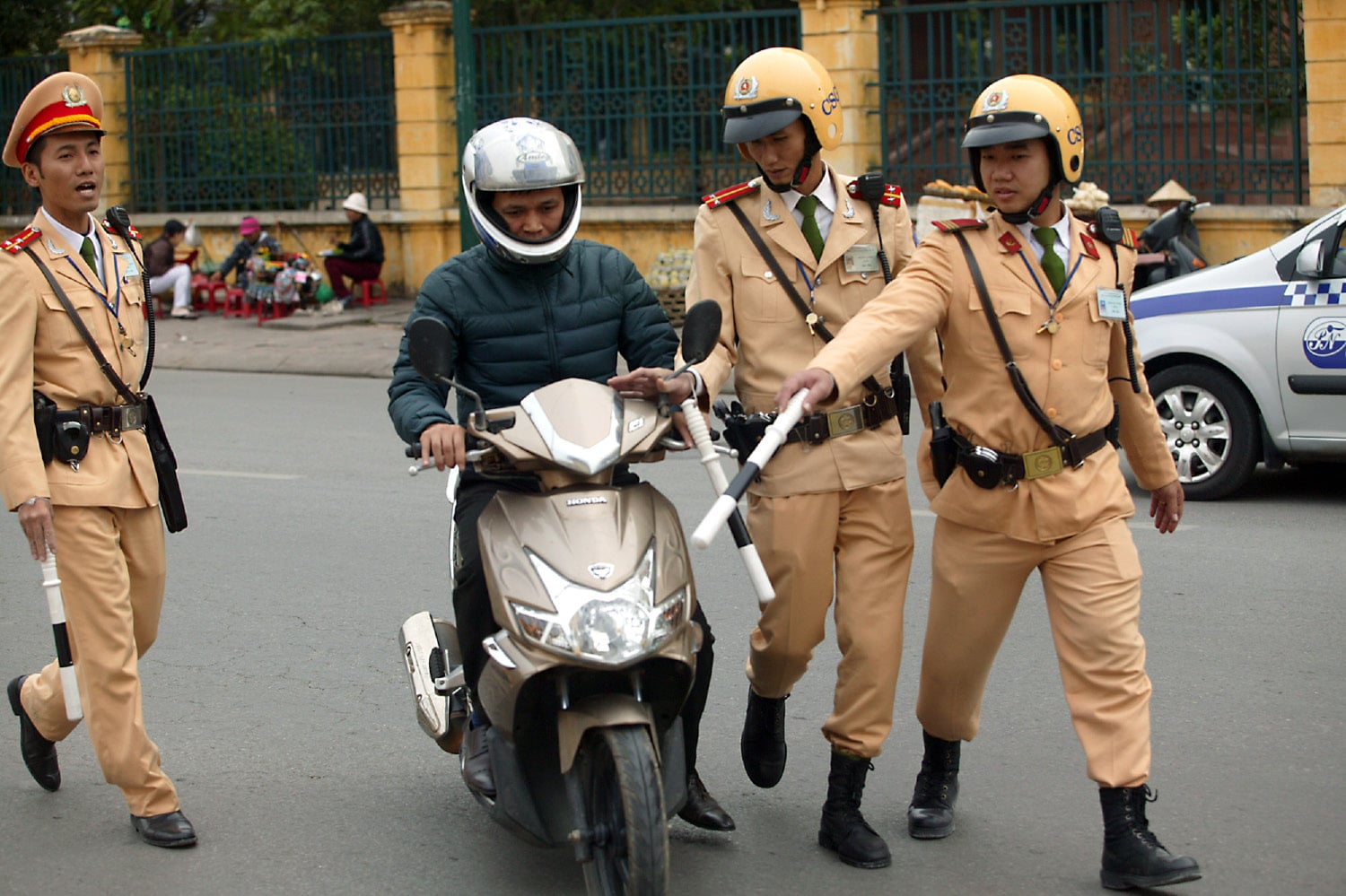 Traffic police in vietnam detain an errant motorcyclist