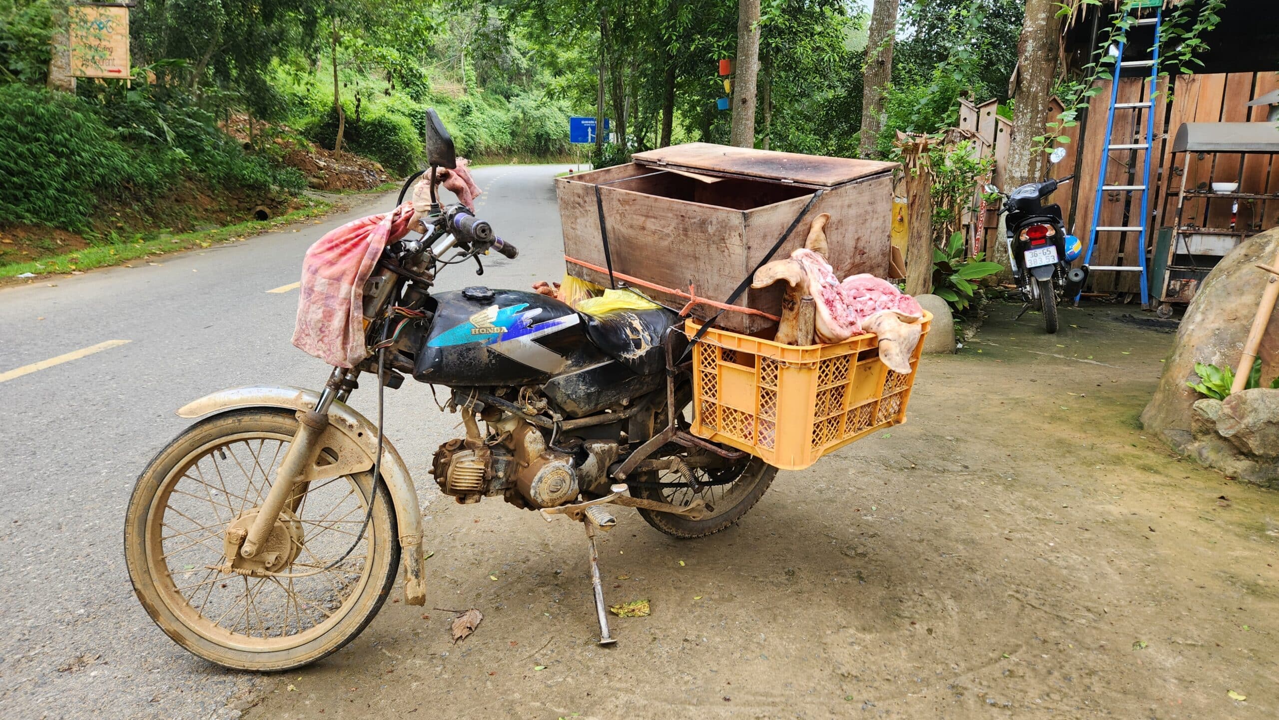 a mobile butchers shop on a Honda win in vietnam