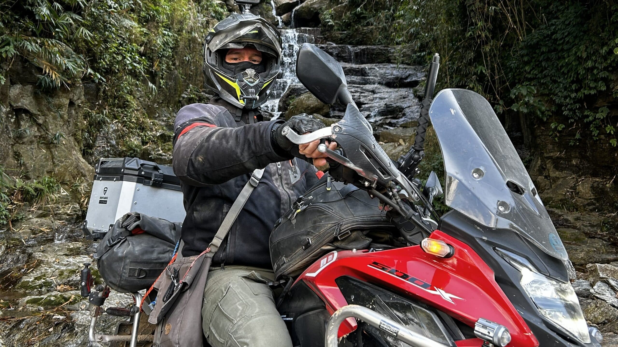 Danny on CB500x by a waterfall