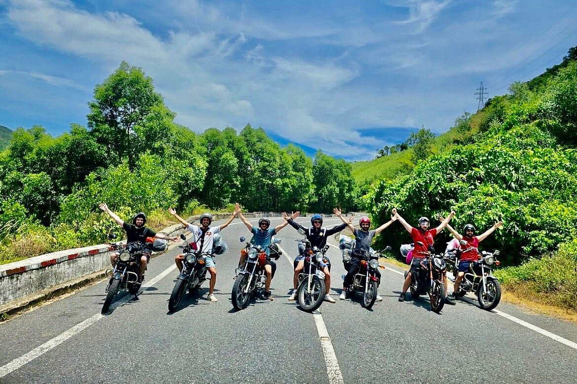 a group of happy riders on empty highway at tet