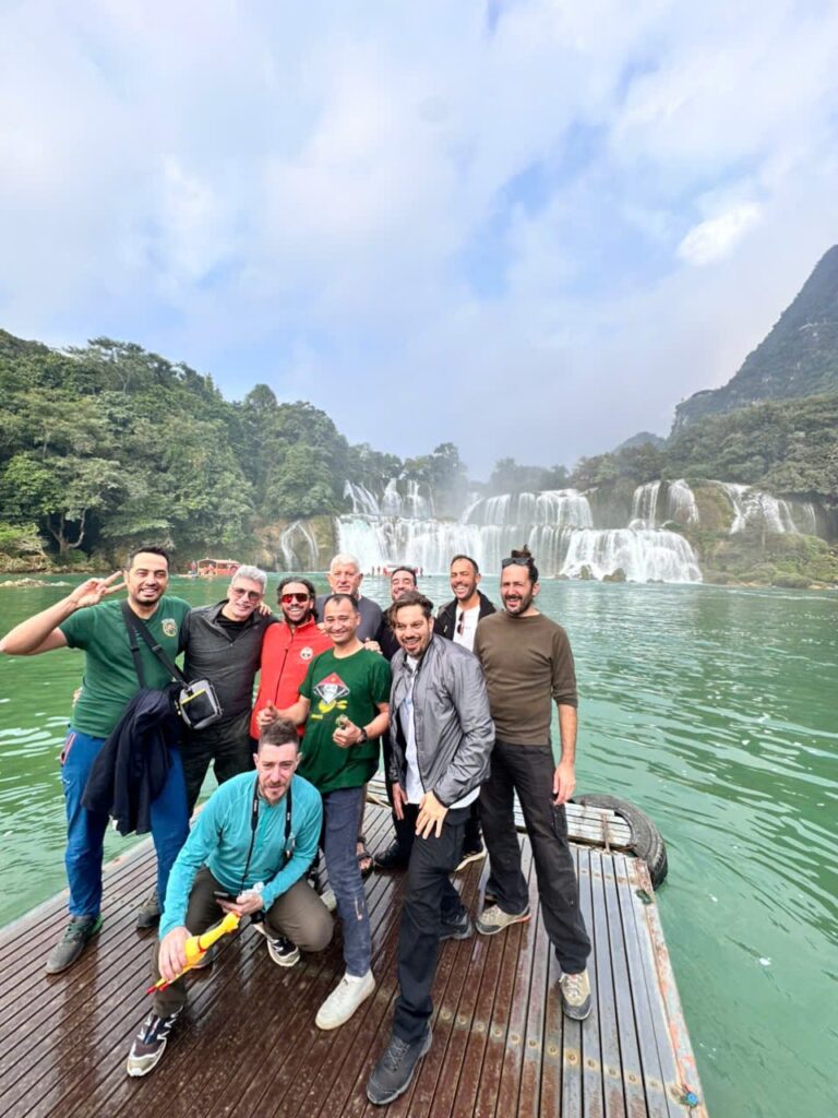 A group of motorcycle tourists enjoying a raft ride at the base of the majestic Ban Gioc Waterfall on the China-Vietnam border.